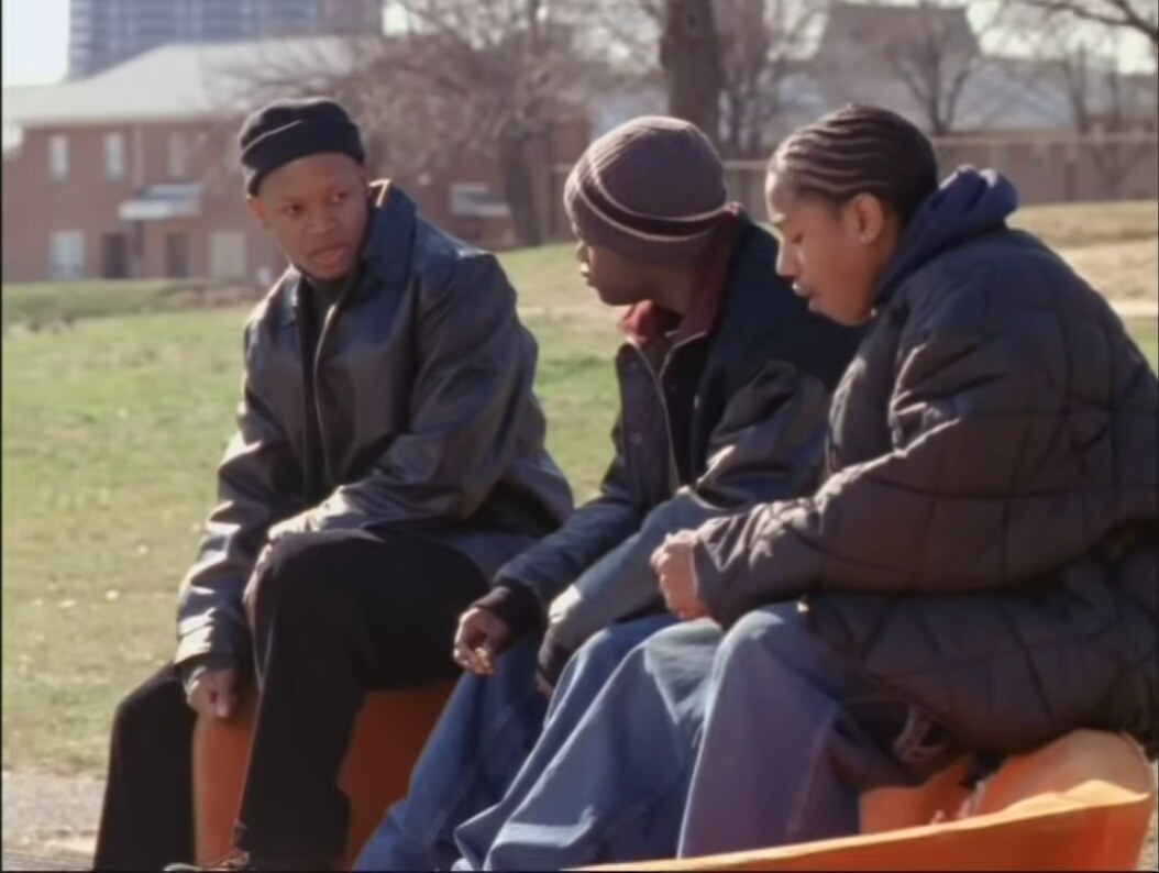 Wallace, Poot, and D’Angelo on a bench in The Wire’s chicken nuggets scene